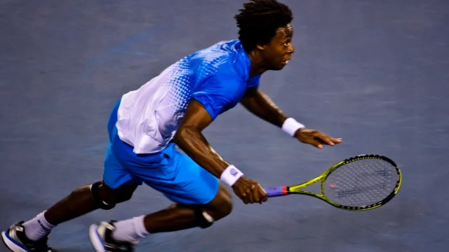 Gael Monfils celebra su victoria en el US Open 2026, con el público de fondo.