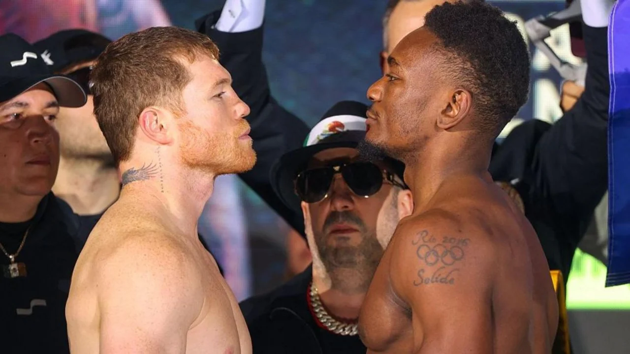 Saúl 'Canelo' Álvarez y Christian Mbilli en el careo de pesaje en Riad, con los cinturones de la WBC de fondo.