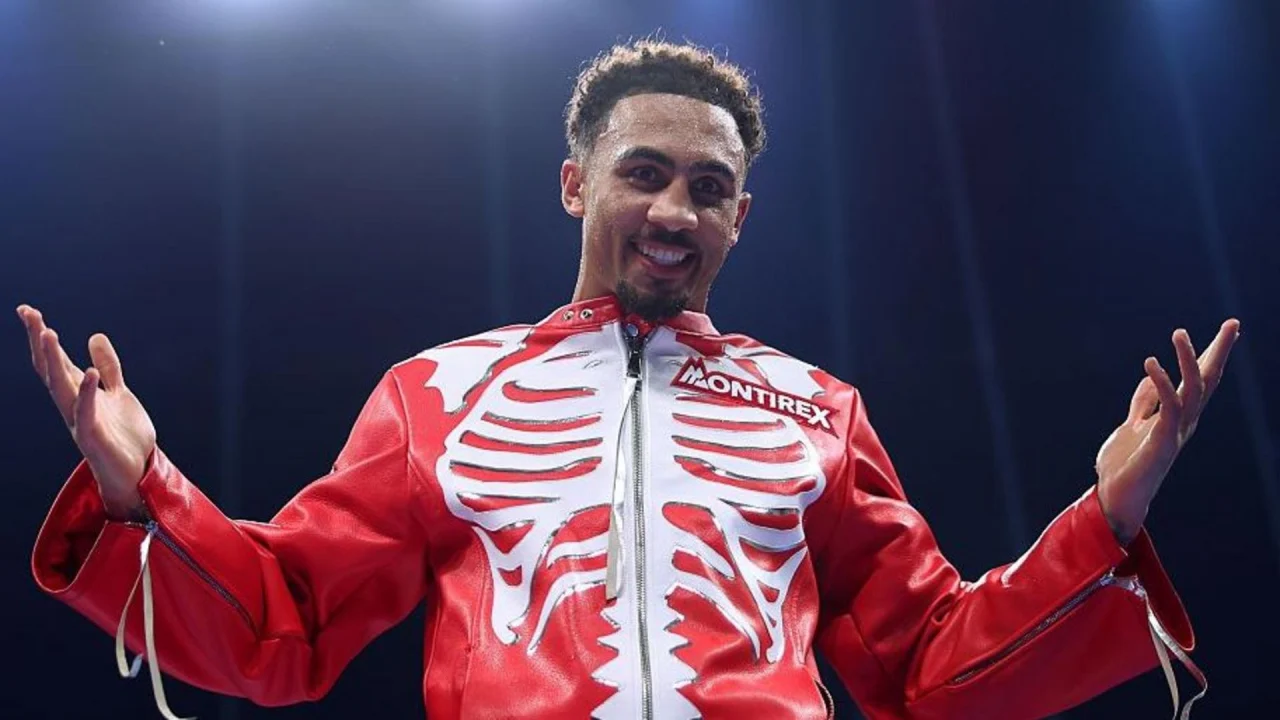 Ben Whittaker celebra después de un combate de boxeo con los guantes en alto.